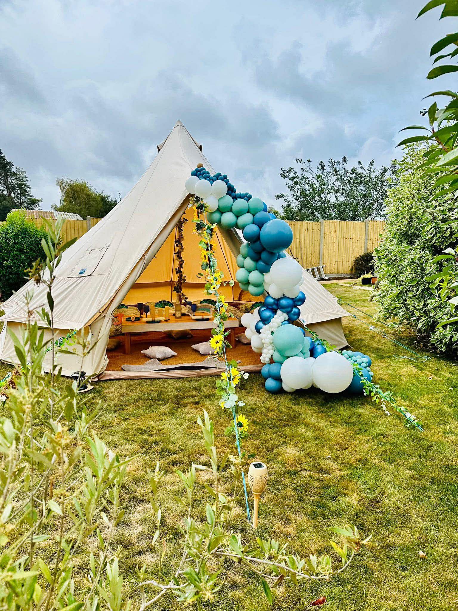 Bell tent with teal balloon arch